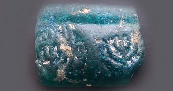 Bracelet Fragment Adorned with Menorah Motifs Discovered A fragment of a glass bracelet adorned with menorah symbols. (Yoli Shwartz/IAA)